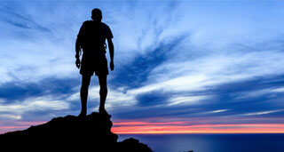 male on top of mountain in santa monica during sunset as part of prescription drug detox therapy