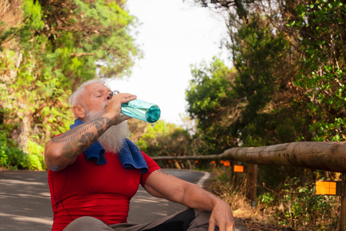 a man drinking a water as part of his detox program from drugs