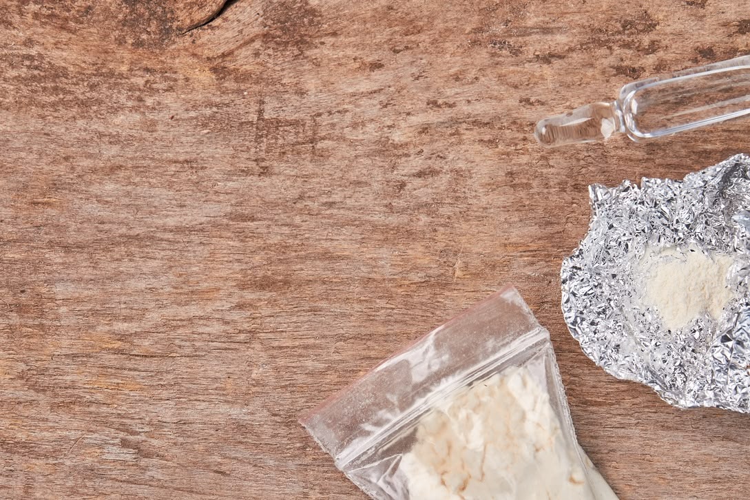 a crystal meth and a foil in a wooden background
